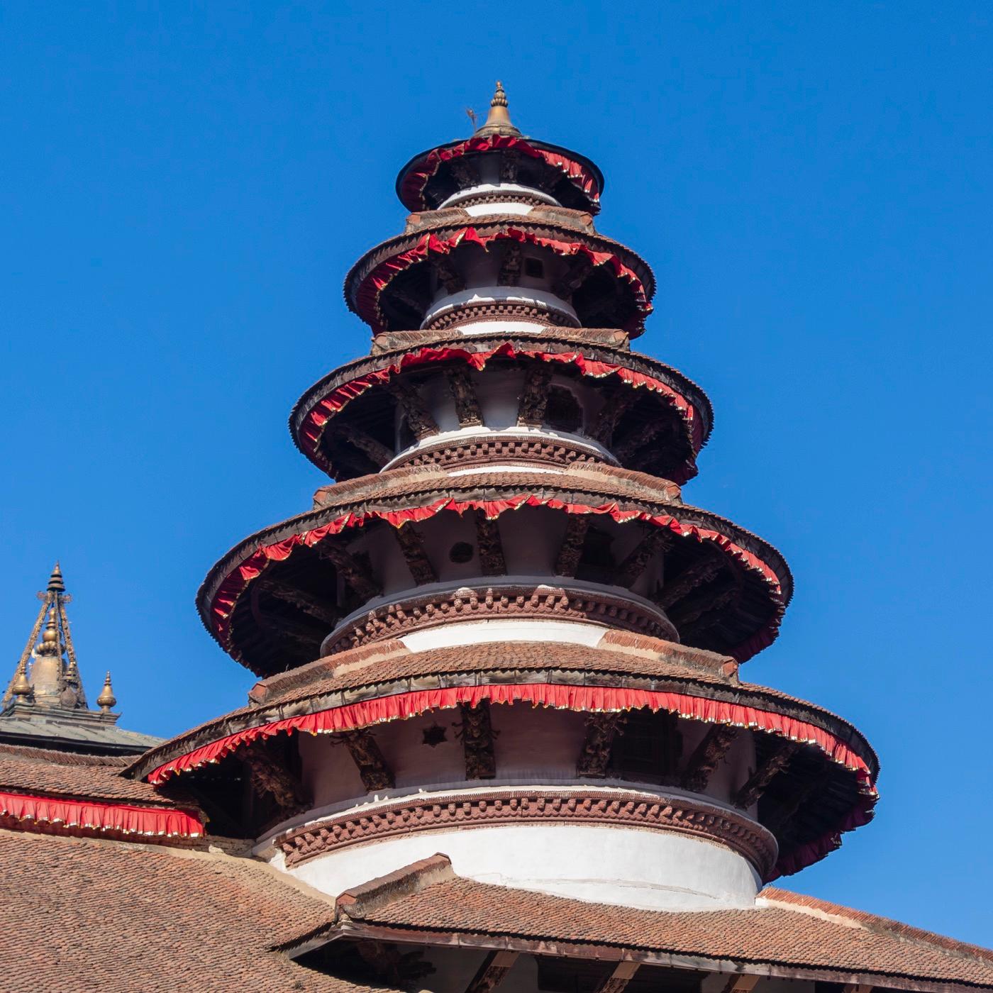 The multi-tiered pagoda roofs of Kathmandu Durbar Square against a clear sky